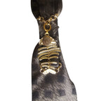 Dettaglio nodo cravatta gioiello Mystic Fish Gold con charm a forma di lisca di pesce di colore oro